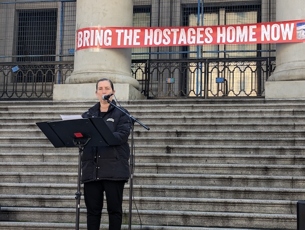 photo - Daphna Kedem speaks at one of the weekly rallies she organizes to unite the local community and express solidarity with the Israeli hostages being held by Hamas