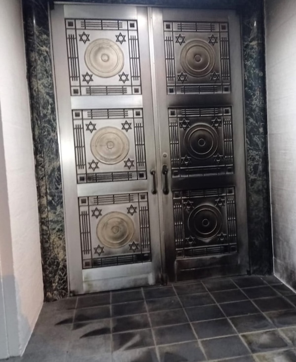 photo - The doors and the flooring outside the entrance of Congregation Schara Tzedeck were damaged when an arsonist set fire to them the night of May 30