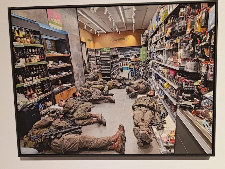 photo - Batia Holini’s photo of Israeli soldiers sleeping on the floor of a grocery store near Kfar Aza on Oct. 8 is one of the works in the exhibit Album Darom