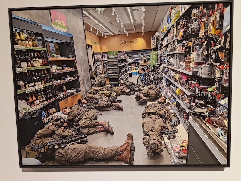 photo - Batia Holini’s photo of Israeli soldiers sleeping on the floor of a grocery store near Kfar Aza on Oct. 8 is one of the works in the exhibit Album Darom