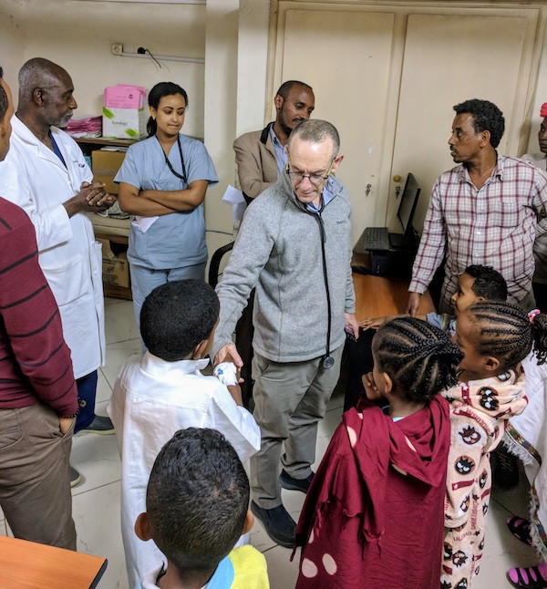 photo - Dr. Oheneba Boachie, left, and Dr. Rick Hodes, centre, with patients. The JDC spine program in Ethiopia is seeing patients full-time and has evaluated more than 5,000 patients with spine deformities