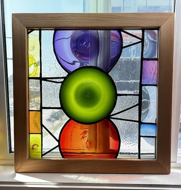photo - A stained-glass panel in a wood frame by Hope Forstenzer