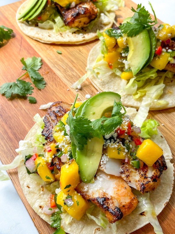 photo - Mango salsa on a fish taco. The Accidental Balabusta enjoyed her husband Harvey’s salsa with quesadillas, marinated salmon and broccoli