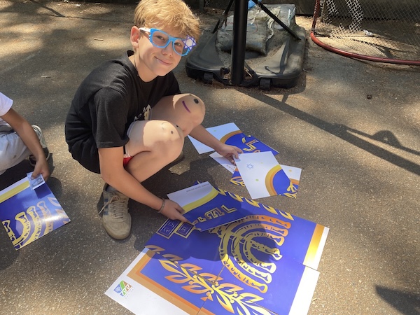 photo - boy at Camp Miriam doing an art project