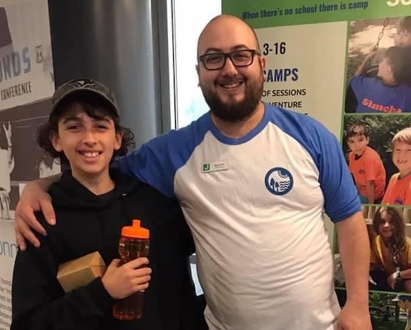 photo - The writer as a kid at Camp Shalom with the camp’s director, Ben Horev