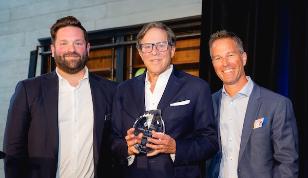 photo - Garry Zlotnik, centre, received the JFS Lighting the Way Award from Brent Davis, left, and Todd Thal at the Innovators event May 26