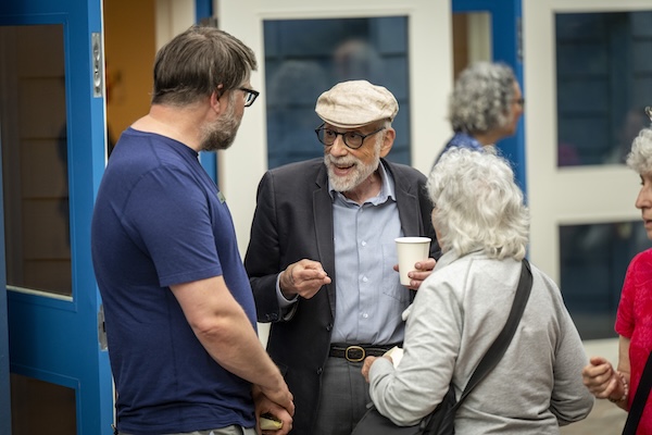 photo - John Fuerst, the driving force behind the renovation project, speaks with attendees after the ceremony