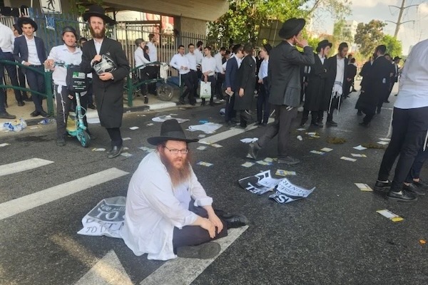 photo - Haredi demonstrators protesting the arrest of draft-dodgers block traffic in Bnei Brak on June 17