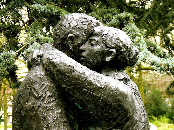 photo - statue of two people hugging